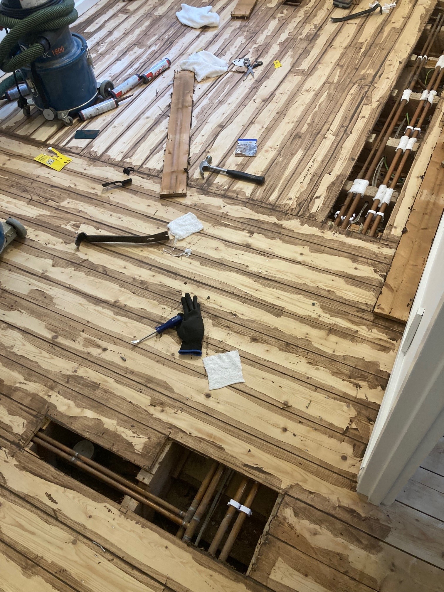 Floor repairs including gap filling and floorboard replacements
