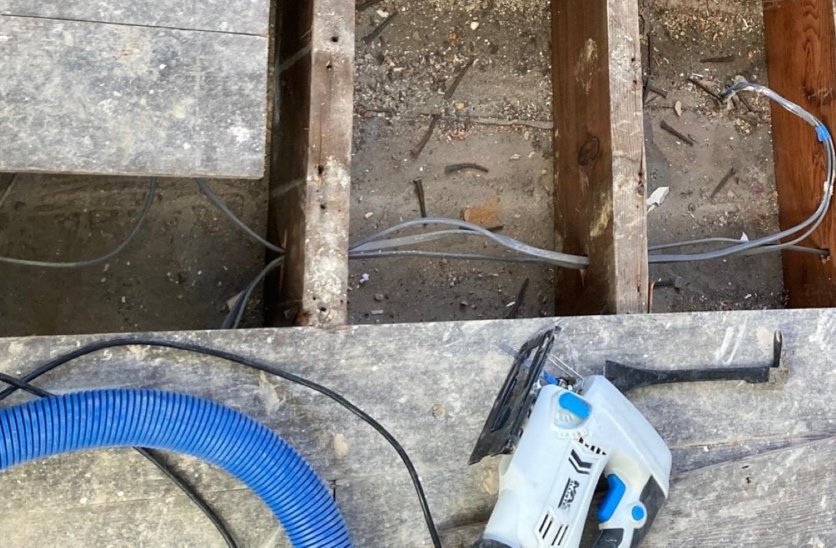 Replacing water damaged floorboards in a hallway